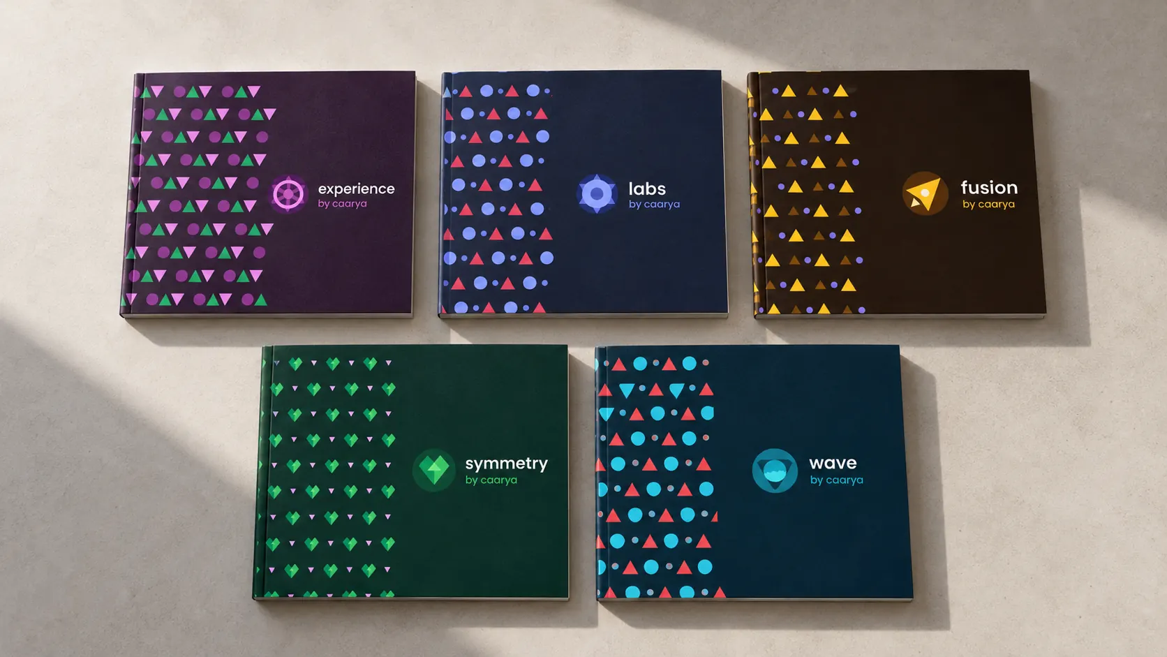 Five Caarya brand booklets presenting the Experience, Labs, Fusion, Symmetry and Wave identities.